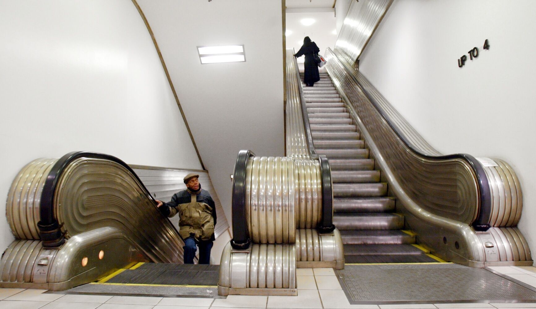 Shoppers ride the Famous-Barr escalator in Jan. 2003